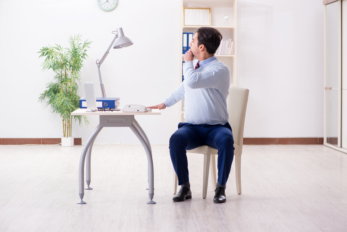 Employee Doing Stretching Exercises in the Office